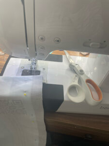 Sewing machine with scissors and fabric under it