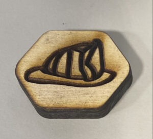 wooden game piece with a fire hat