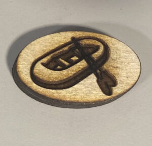 wooden game piece with boat and row