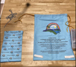 Small blue bag with a larger blue Climatopia drawstring game bag to the right 