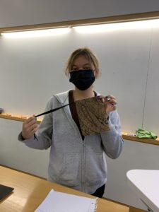 Female student holding a brown bag