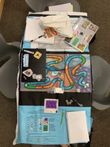 Climatopia game board and game rules set up on desks