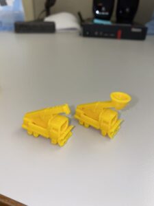 Two yellow truck game pieces