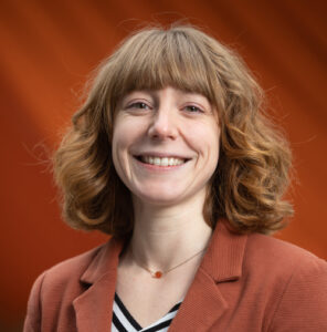 Headshot of Alyssa Lafaro with an orange background
