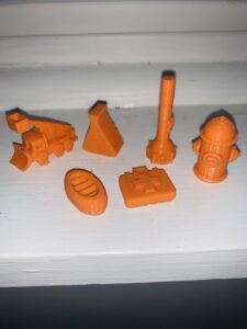 3D game pieces printed out in orange