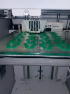 Various green 3D pieces in 3D printer
