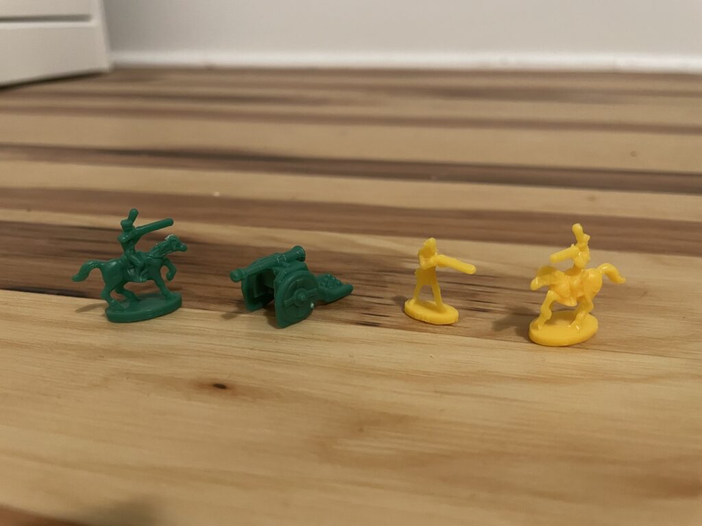 Green and yellow Risk game pieces
