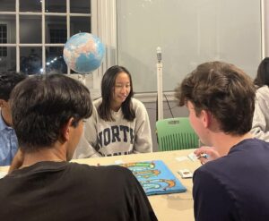 a group of people sitting around a table playing climatopia