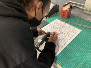 Femal student cutting game cards