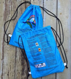 Blue-colored draw string game bags set on a wooden surface