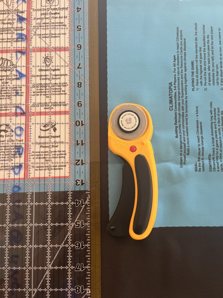 A clear ruler on a straight line seperating the game rules and game piece bag