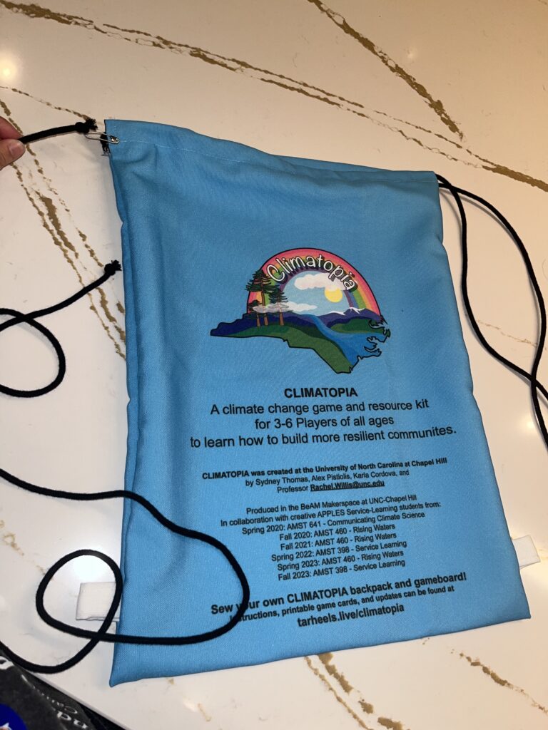 Climatopia drawstring bag with cord pinned to the top left