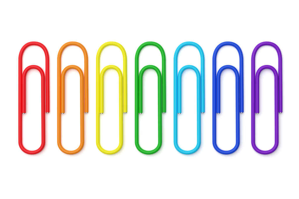 Different colored paper clips lined up side by side