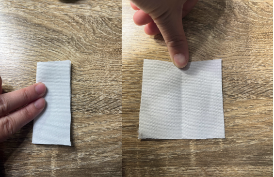 Side by side pictures of a small white piece of fabric folded in half and then not folded but a crease shown on the other picture