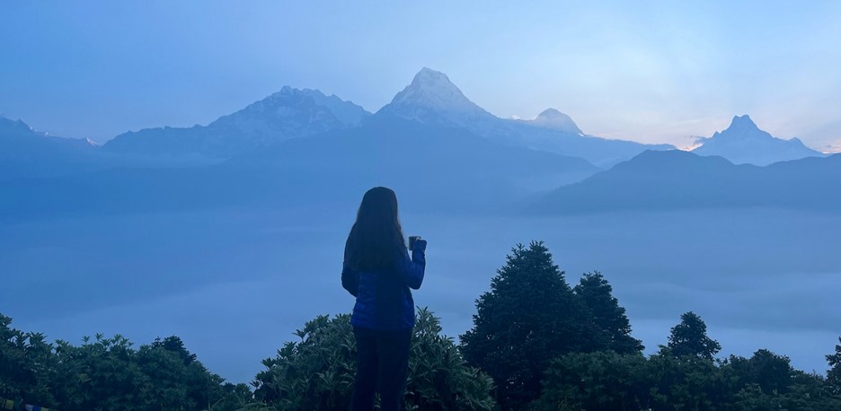 Ellina overlooking the Annapurna mountain range from the top of Poon Hill