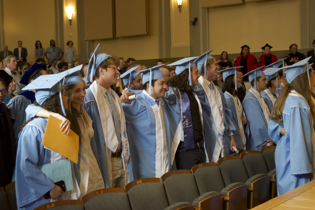 2024 Graduates stand together and sing Hark the Sound at the department commencement ceremony.