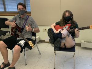 Students Alexander Weir and Ambrosia DeConto pose during a guitar lesson.