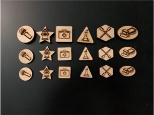 3 sets of the 6 climatopia game pieces set next to each another atop a black surface
